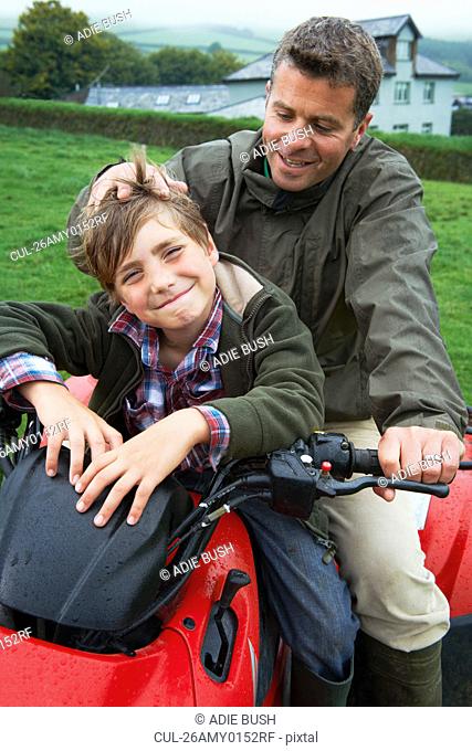 Father and son on quad bike