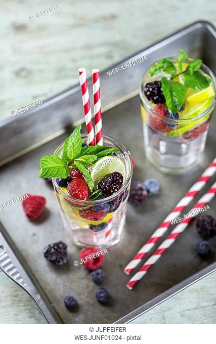 Infused water with fresh berries, raspberry, blueberry, blackberry, mint and lime