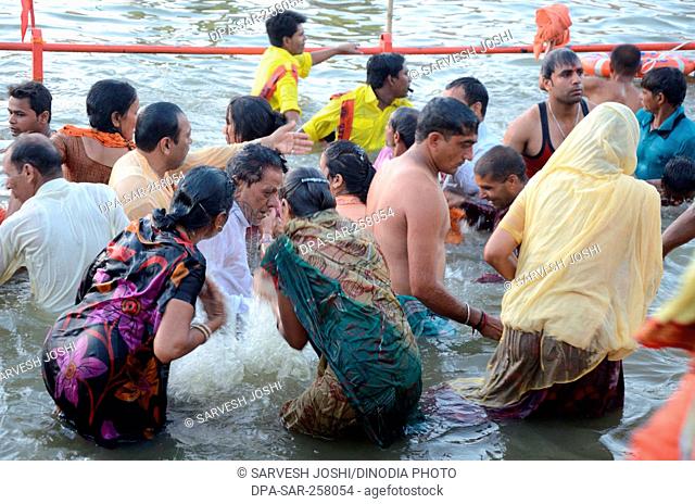 Pilgrims taking holy dip in river, kumbh mela, ujjain, madhya pradesh, India, Asia