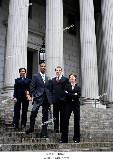 Low angle view of lawyers standing on the steps of a courthouse