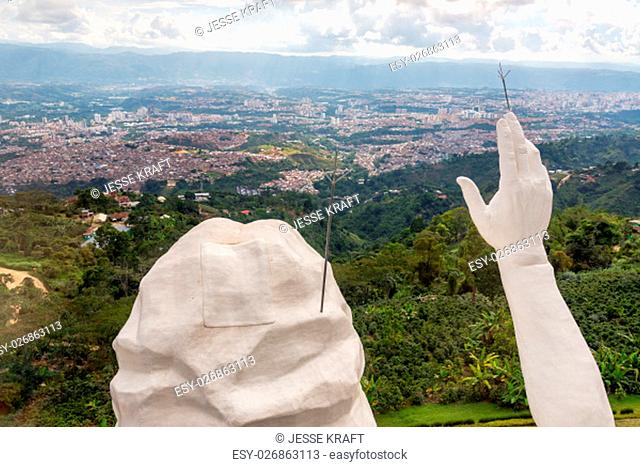 Head and hand of El Santisimo statue with Bucaramanga visible in the background
