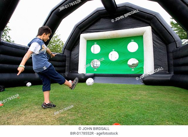 Boy playing a football scoring game at a Parklife summer activities event