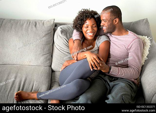 Portrait of mid adult couple sitting on sofa