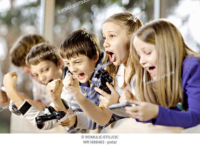 Children playing video game, Osijek, Croatia, Europe