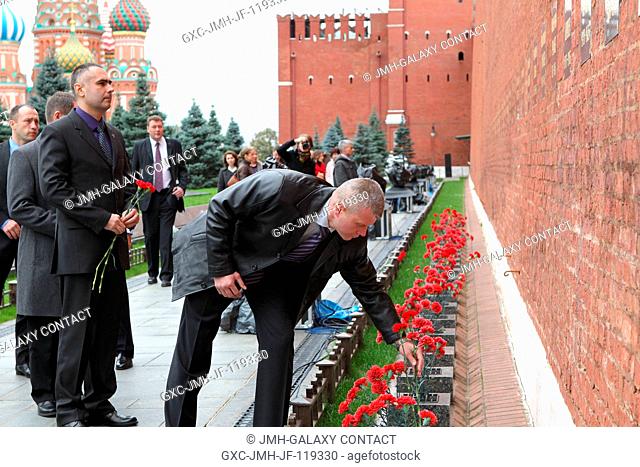 Expedition 33 Soyuz Commander Oleg Novitskiy plants a flower at the Kremlin Wall in Moscow where Russian space icons are interred Sept