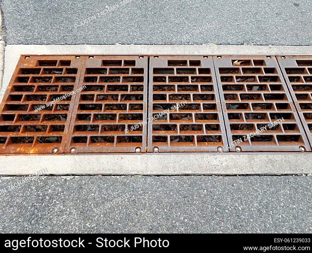 iron metal grate or drain in asphalt road or street
