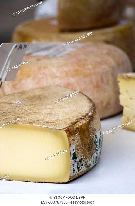 Various cheeses on a market stall