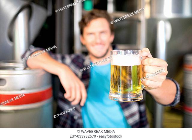 Close up of beer glass being held by worker