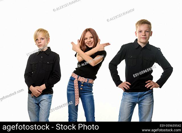 Happy children on a white background, a girl directed improvised pistols from her hands to the side of her brothers
