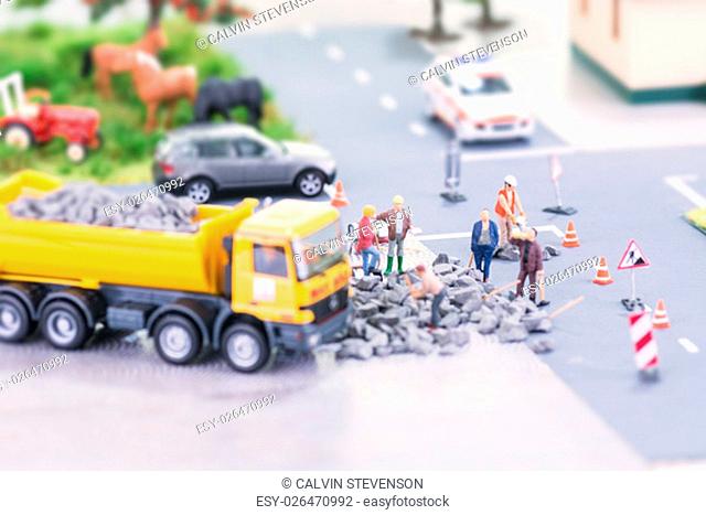Road works with miniature workers
