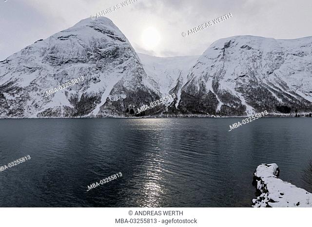 Mountain range on the east shore of the Kjösnesfjord, street Skei - Sogndal, sunray on water surface, winter, snowy scenery, Sogn og Fjordane, Norway