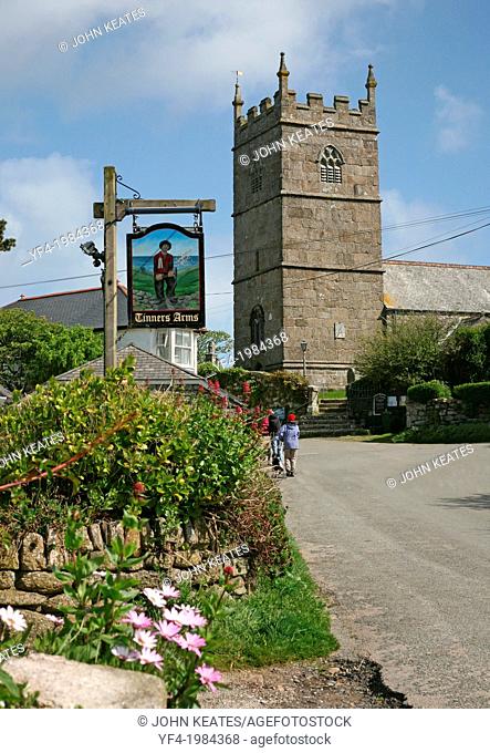 The Tinners Arms pub sign and the village church of St Senara at Zennor Cornwall England UK