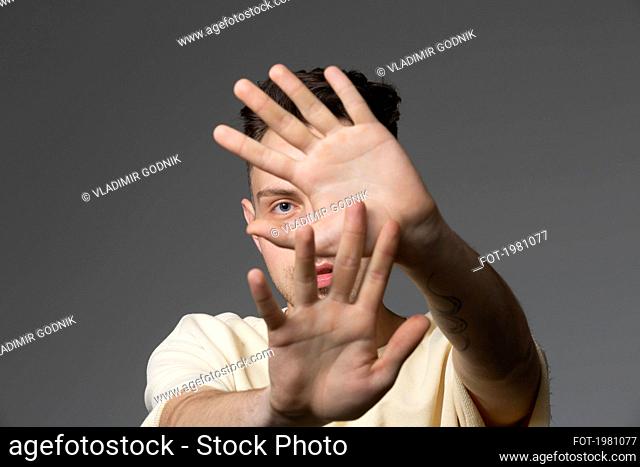 Portrait man covering face with hands