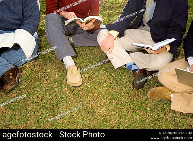 Four students sat outdoors