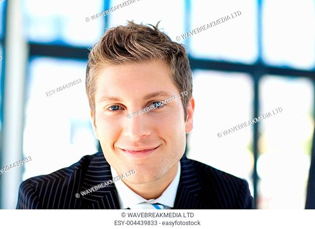 Young businessman smiling at the camera