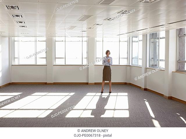 Businesswoman standing in empty office