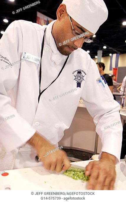 Americas Food and Beverage Show, Black male chef, cutting board, knife. Convention Center. Miami Beach. Florida. USA