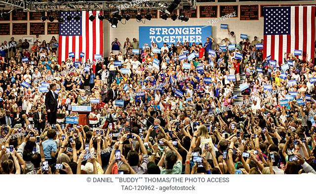 2016 Democratic Presidential Nominee, Hillary Rodham Clinton, and Colorado Gov. John Hickenlooper wave to a crowd at Adams City High School in Commerce City