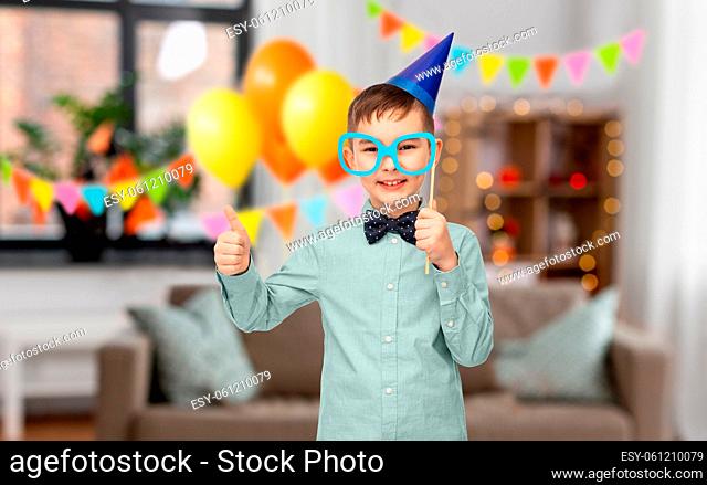 little boy in birthday party hat with glasses