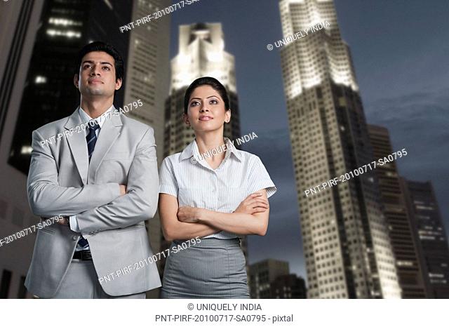Business couple standing in a city