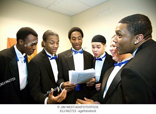 Detroit, Michigan - Young men warm up their voices as the Mosaic Singers prepare for a concert  The Mosaic Singers are part of Mosaic Youth Theatre