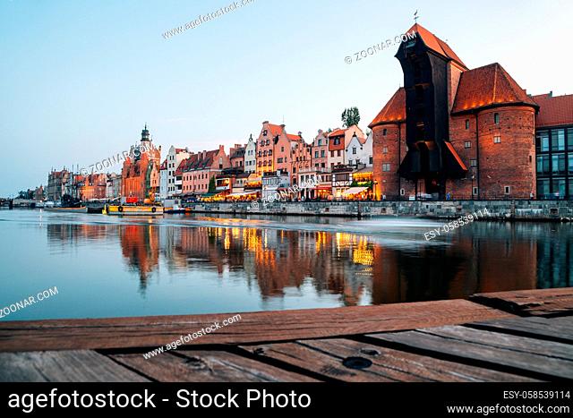 Medieval port Crane and old town with river at sunset in Gdansk, Poland