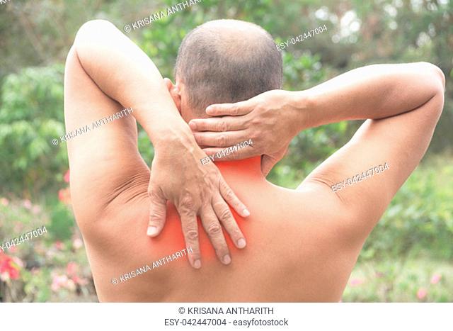 Man suffering from neck and shoulder pain. Acute pain in a man muscle concept with red spot