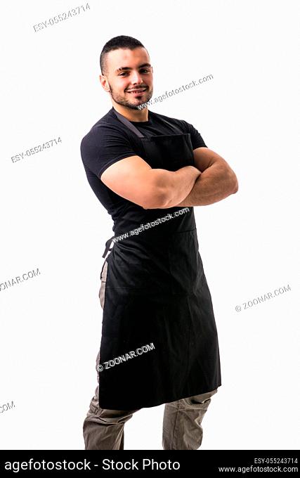 Portrait of handsome chef in black apron against of white background. Studio shot