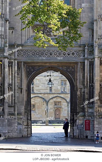 England, Oxfordshire, Oxford, Bursar and child at the gate of Christ Church College. The college has produced thirteen British prime ministers