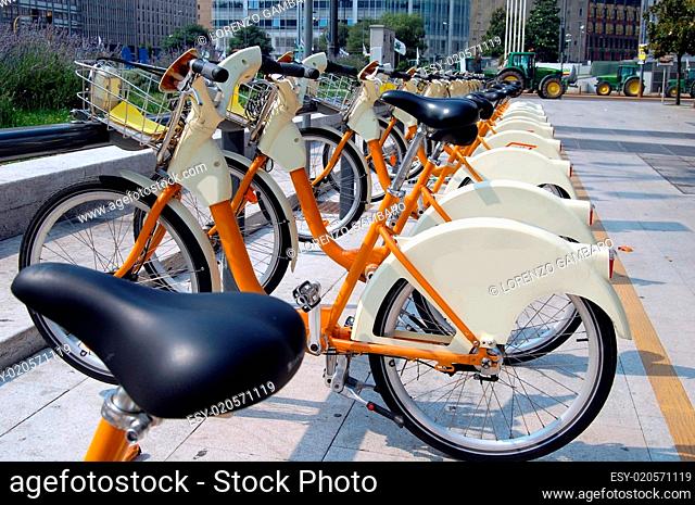 parked yellow bicycles, concept of bike sharing