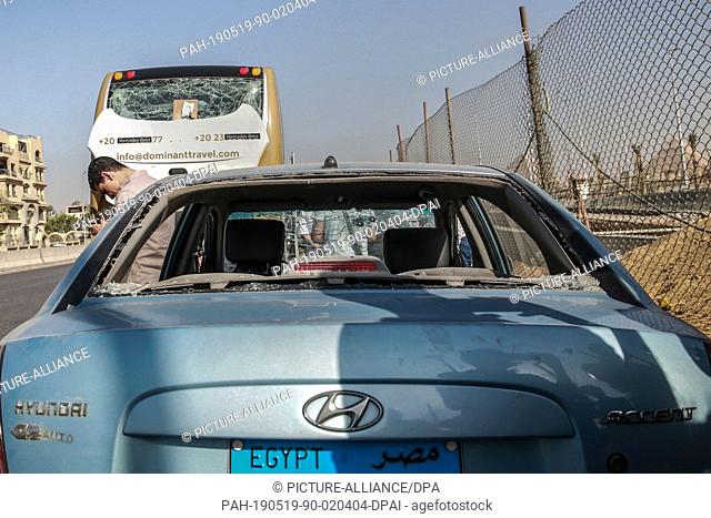 19 May 2019, Egypt, Giza: A view of a damaged tourists' bus and a car at the site where a bomb went off near the Grand Egyptian Museum in Giza.