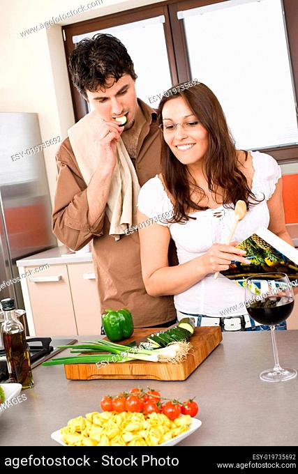 Cooking - happy couple together in modern kitchen