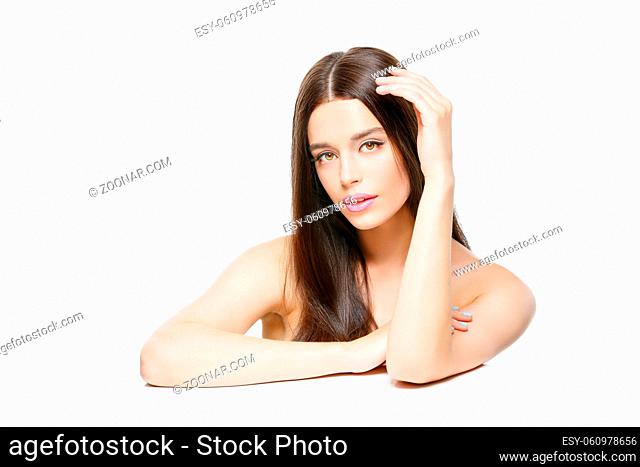 Beautiful young woman with long hair touching head. Isolated over white backgound. Copy space
