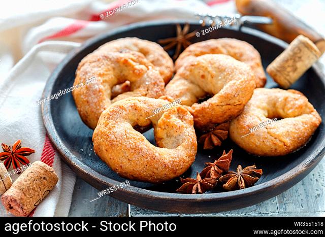 Dish with homemade wine donuts on white wooden table, selective focus