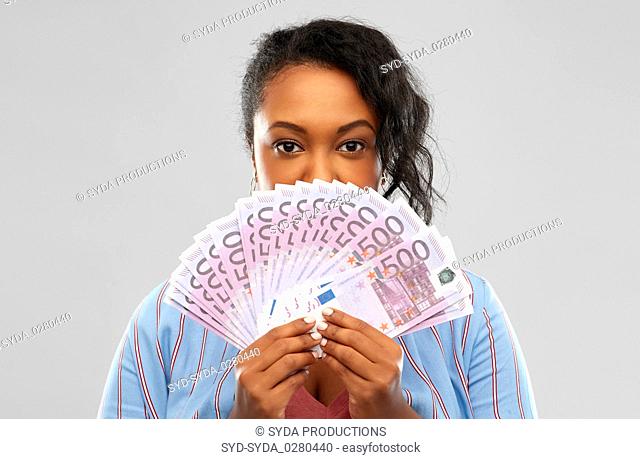 excited african american woman with euro money