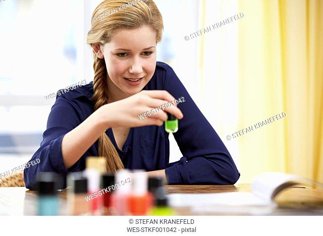 Female teenager choosing nail varnish