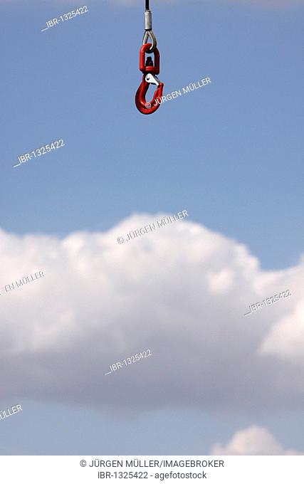 Crane hook against a blue sky