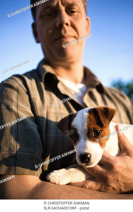 Man holding puppy