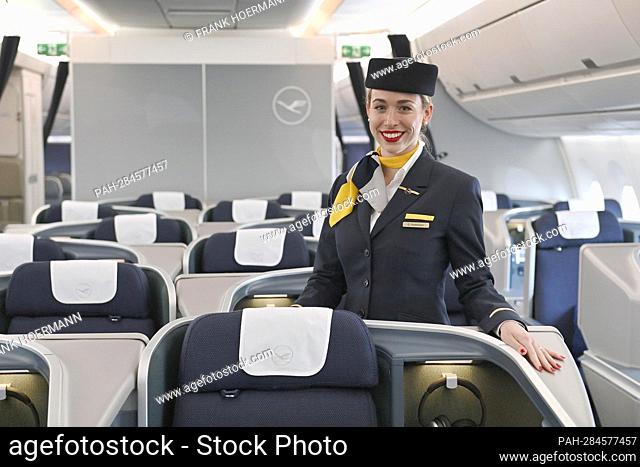 Flight attendant, stewardess, steward, cabin crew in empty business class. Lufthansa aircraft christening Airbus A350 MUENCHEN on April 29th