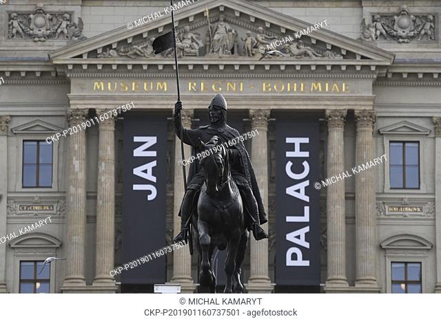 Black flags commemorating late student Jan Palach with his name and silhouette hang on the building of National Museum as a statue of Saint Wenceslas is seen...