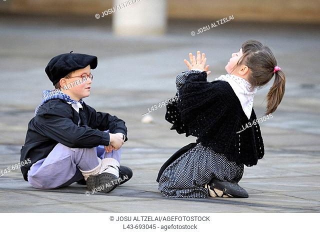 Childs playing with typical costume of Euskadi, Mondragon, Spain