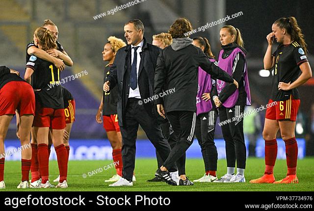 Belgium's head coach Ives Serneels comforting his players after losing a game between Belgium's national women's soccer team the Red Flames and Sweden, in Leigh