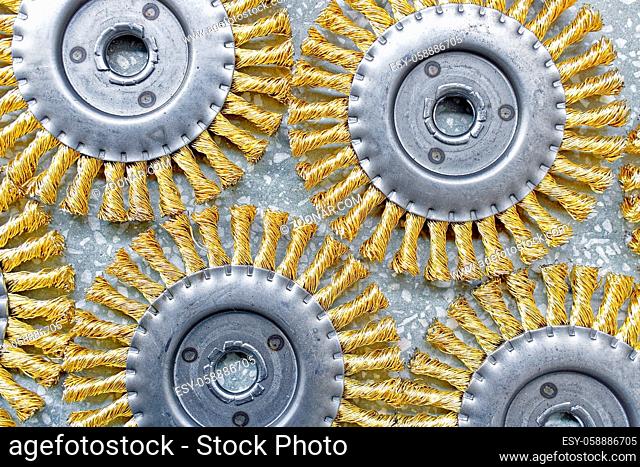 Disk brush. Round brush with metal pile or bristles for processing materials. Solid background close-up