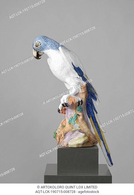 Blue Macaw, Figure of painted porcelain. The figure represents a parrot (macaw) sitting on a stump with leaves. The parrot has a blue scaly neck and head and a...