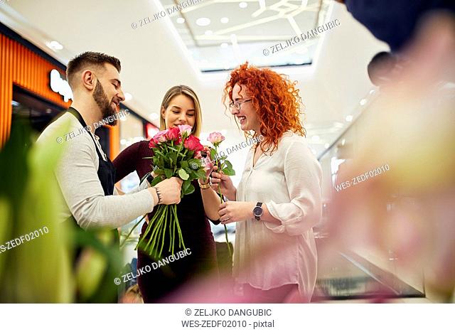 Florist advising customers in flower shop