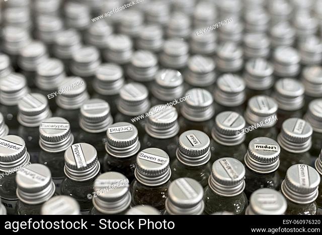 Assortment of essential oils in small glass bottles with name on a cover. Selective focus
