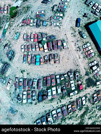 Overhead aerial view of cars wreckage gathered in a countryside parking
