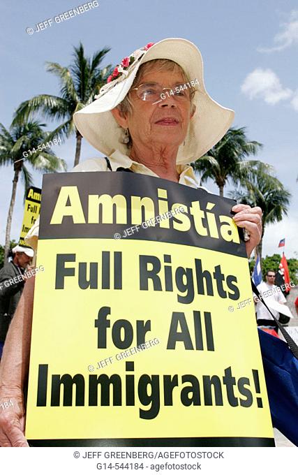 May Day Rally, amnesty, immigration, Hispanic senior female. Torch of Friendship. Biscayne Boulevard. Miami. Florida. USA