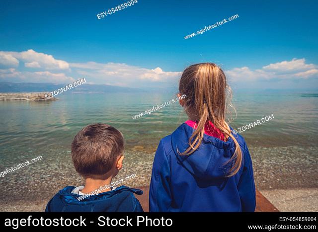 Little children standing on the shore and looking in admiration on Lake Ohrid, Republic of Macedonia