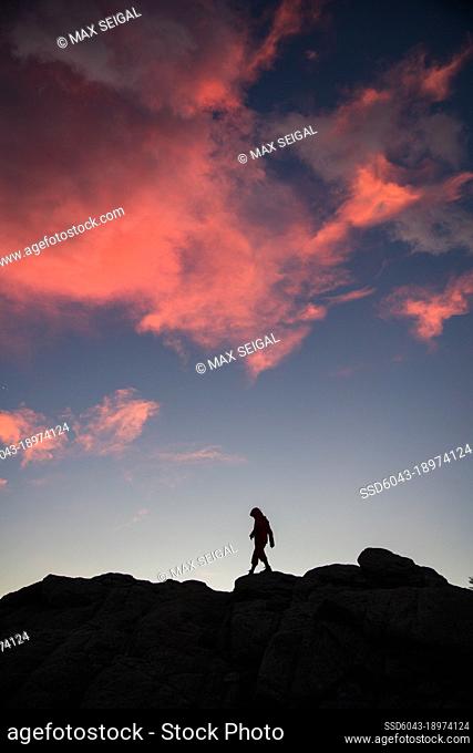 Silhouette of woman hiking along Patagonia mountain range